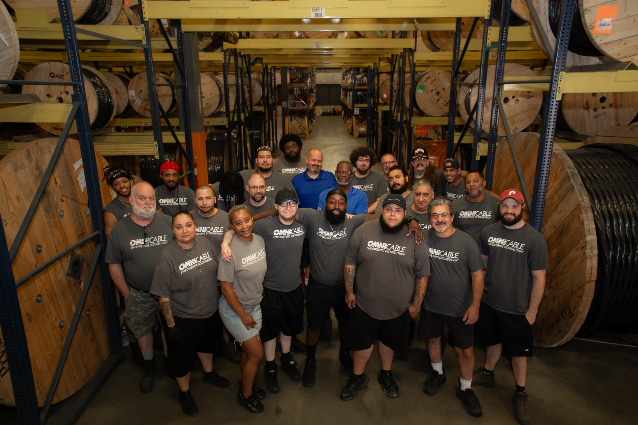 Group photo of workers standing in a warehouse