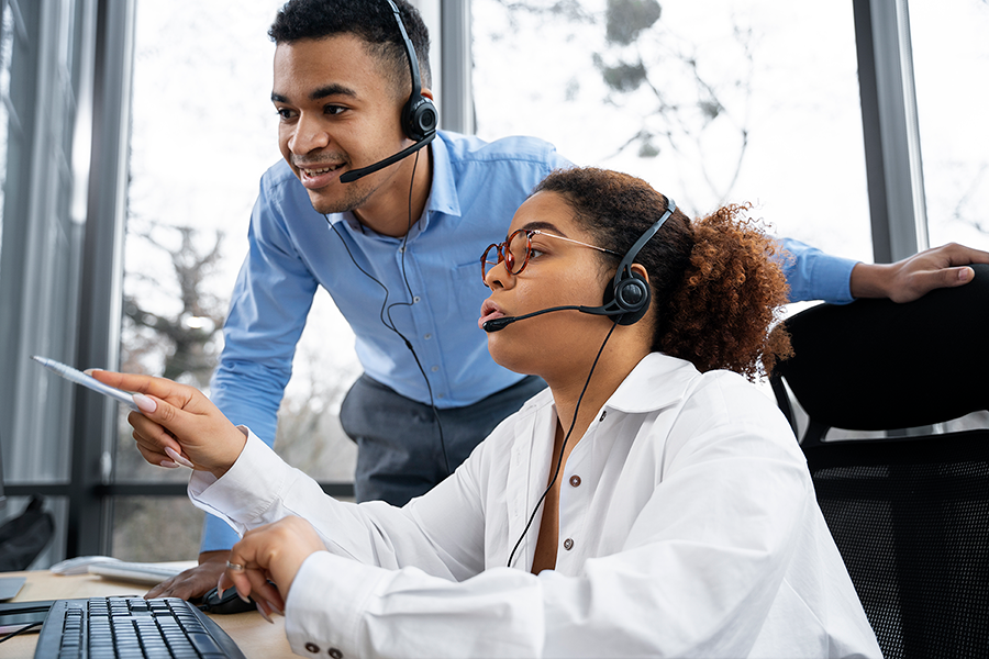 Two customer service representatives in a call center