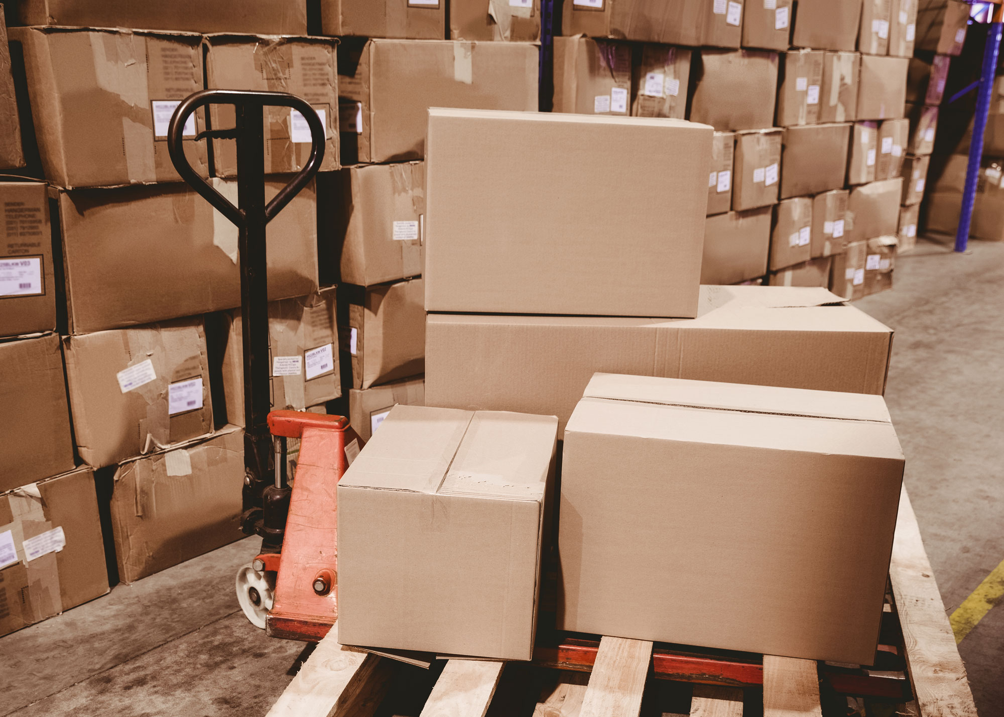 Cardboard boxes on a dolly in a warehouse