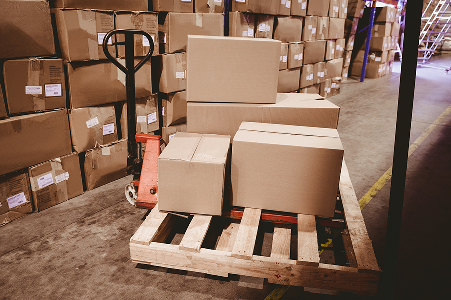 Cardboard boxes on a dolly in a warehouse